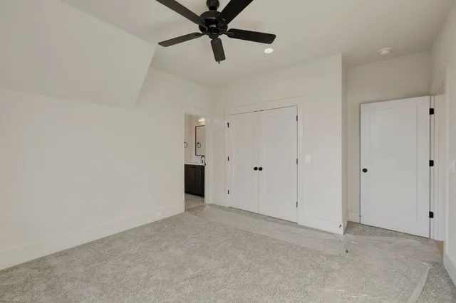 a bathroom with a sink toilet vanity and shower