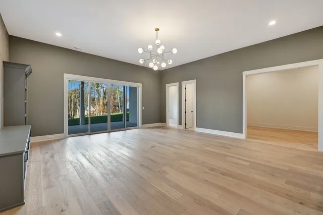 a view of an empty room with a fireplace and a window