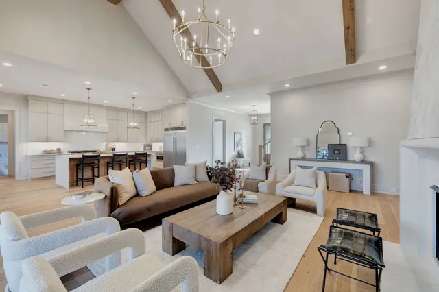 a living room with furniture and a chandelier