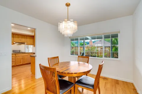 a view of a dining room with furniture wooden floor and chandelier