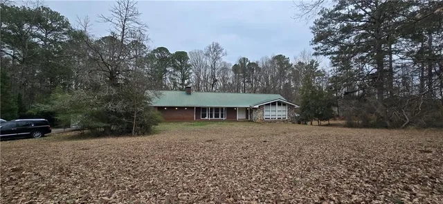 a view of house with backyard