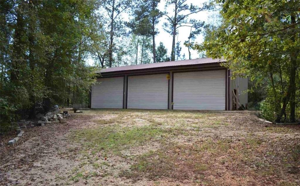 2816 Klondike Road Southwest Conyers, GA 30094 - Photo 4 of 7 a house with trees in the background