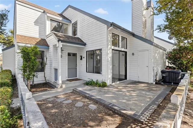 a view of a house with backyard and sitting area