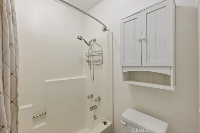 a bathroom with a granite countertop sink a toilet and a large mirror