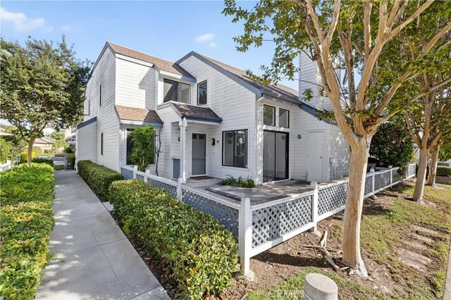 an empty room with wooden floor fireplace and windows