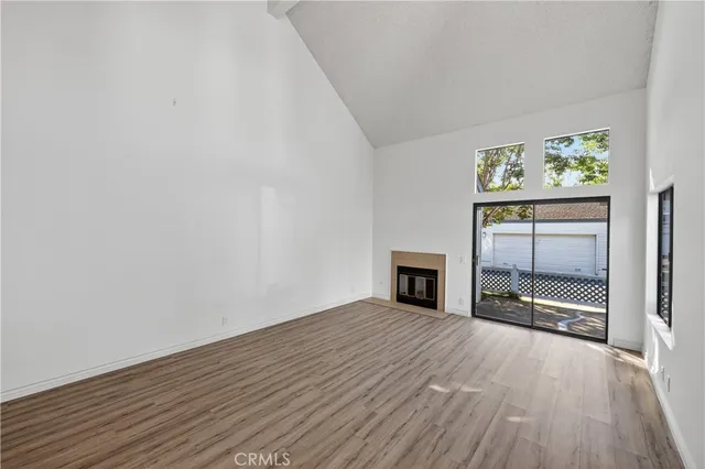 a kitchen with cabinets and wooden floor