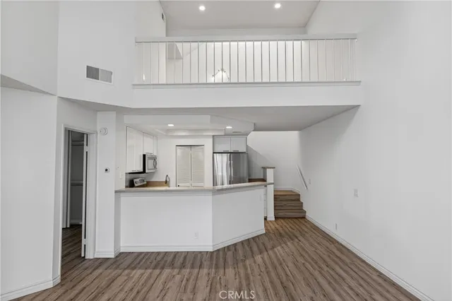 a kitchen with stainless steel appliances a sink and a refrigerator