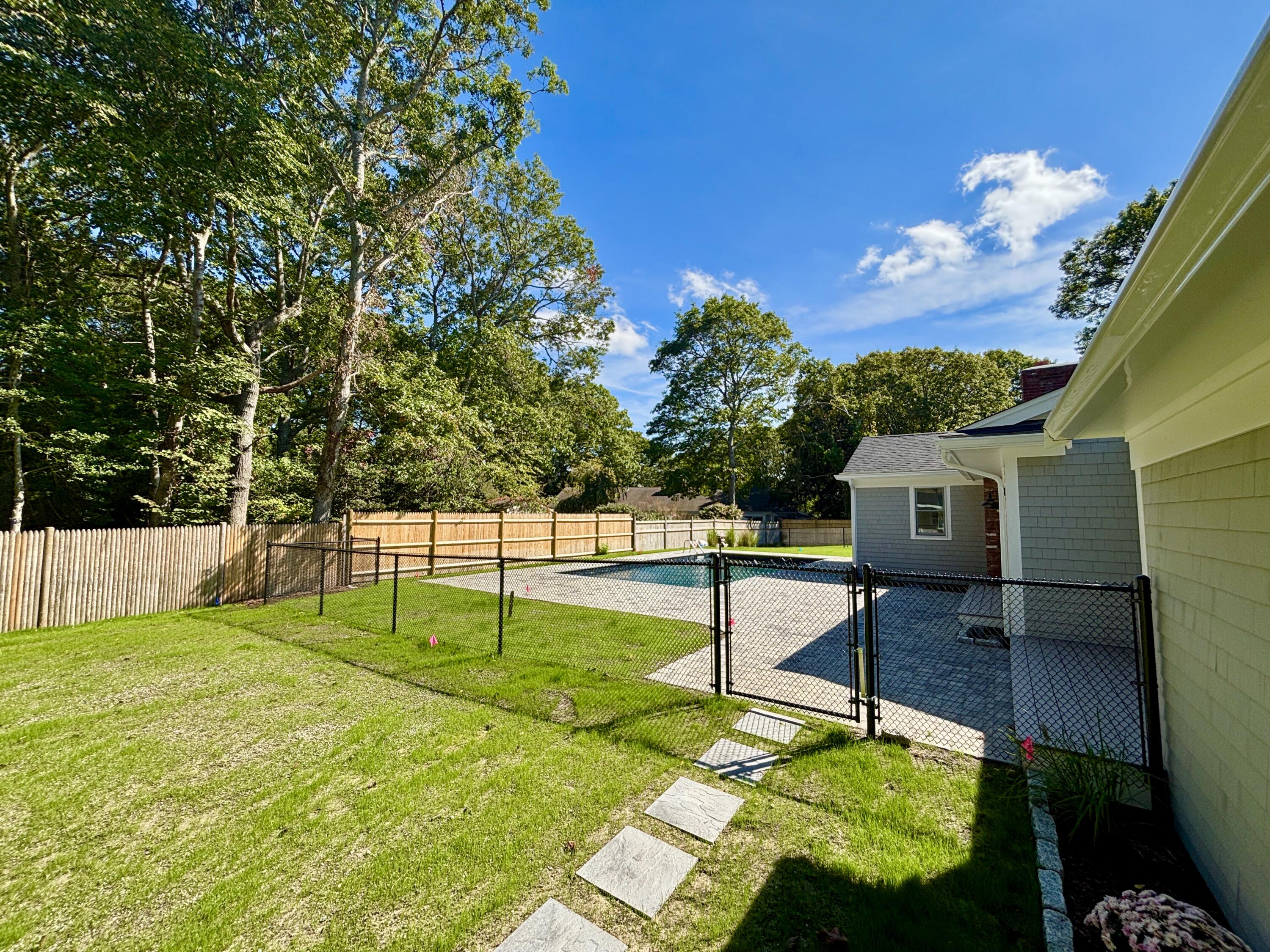 40 Sachem Drive Centerville, MA 02632 - Photo 13 of 56 a backyard of a house with table and chairs