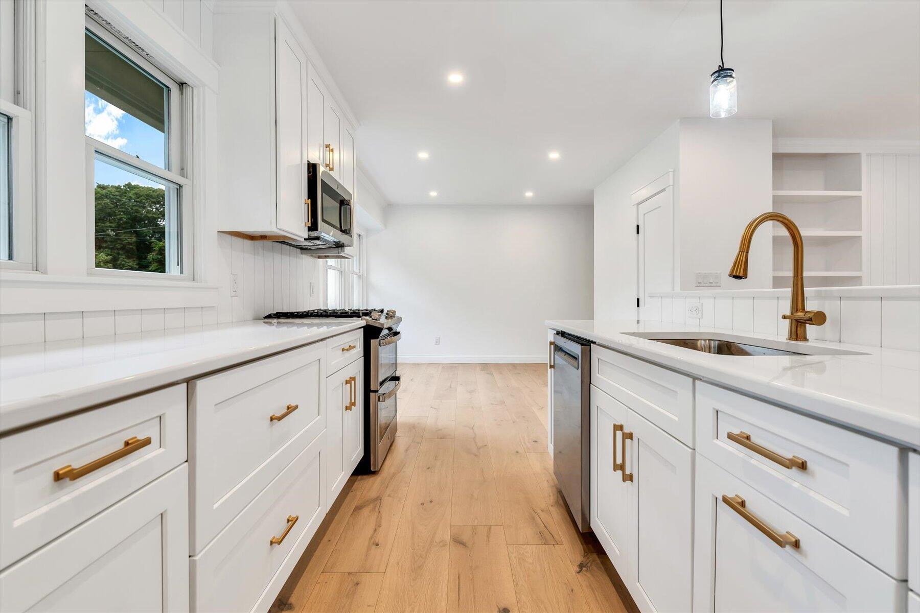 40 Sachem Drive Centerville, MA 02632 - Photo 18 of 56 a kitchen with granite countertop white cabinets and white appliances