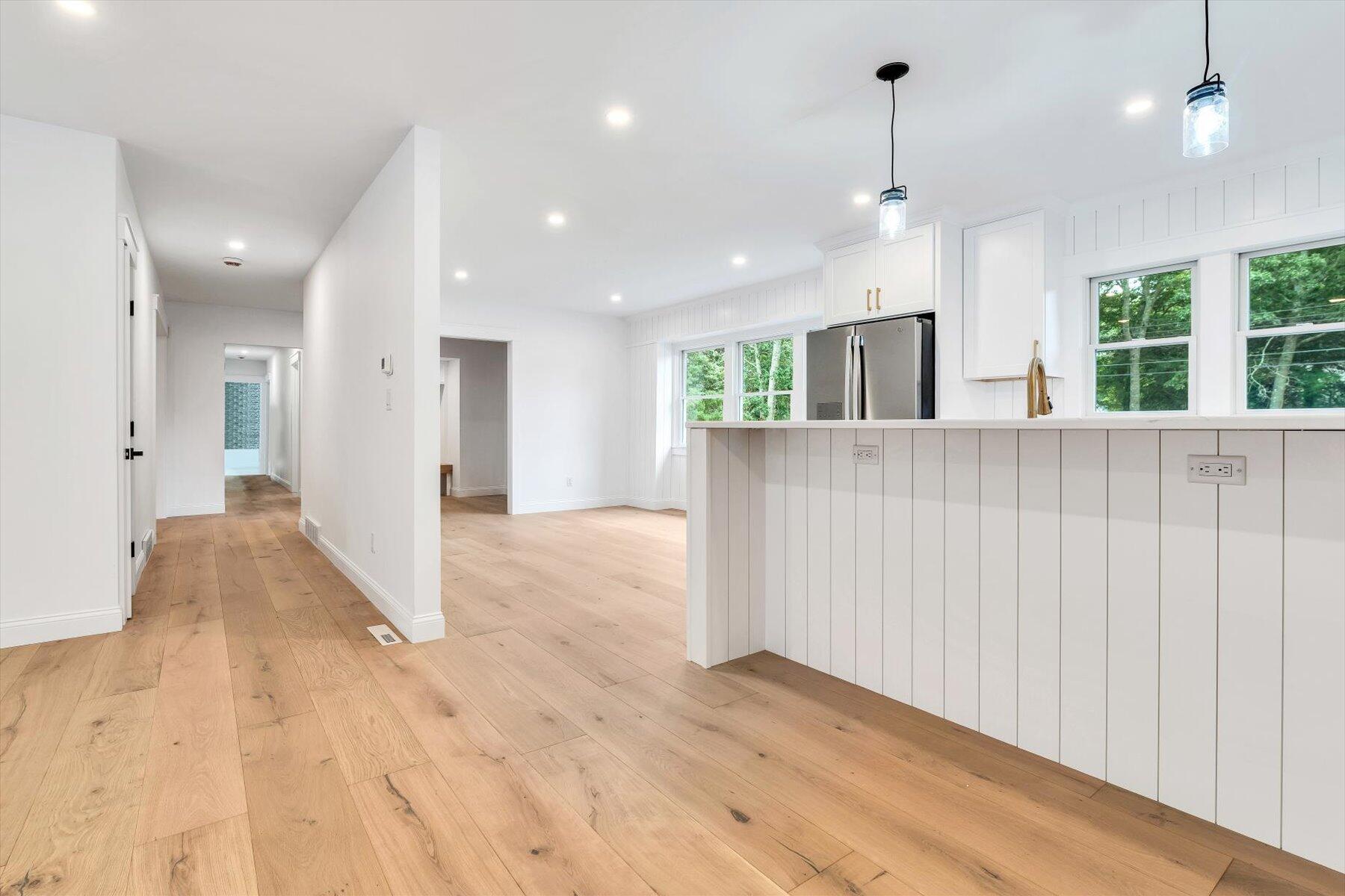 40 Sachem Drive Centerville, MA 02632 - Photo 30 of 56 a view of a kitchen with large windows and a chandelier