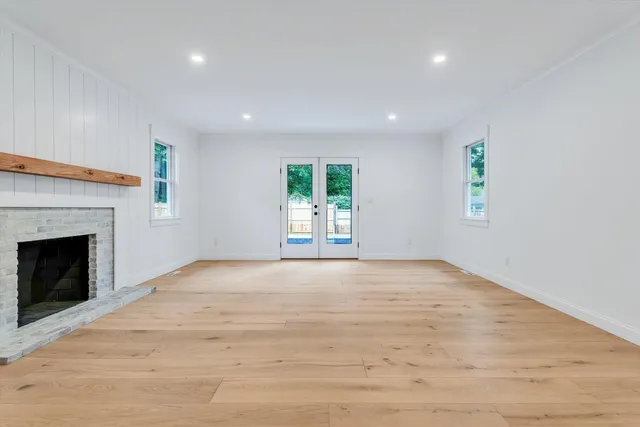 a bathroom with a tub sink and mirror