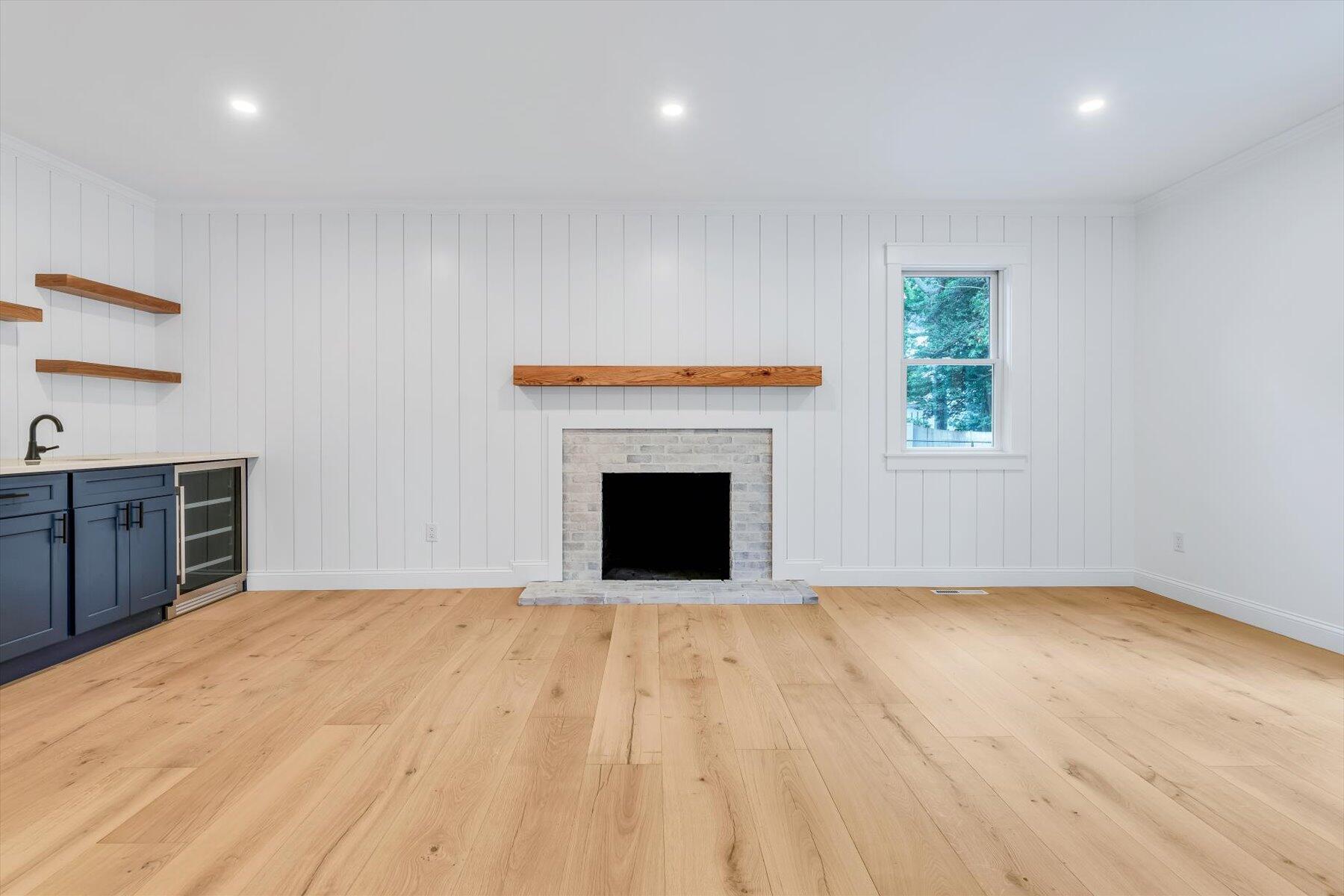 40 Sachem Drive Centerville, MA 02632 - Photo 33 of 56 a view of empty room with wooden floor and fireplace