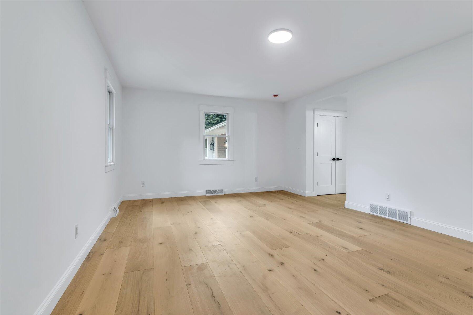 40 Sachem Drive Centerville, MA 02632 - Photo 41 of 56 an empty room with wooden floor and windows