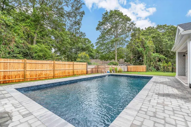 a backyard of a house with table and chairs