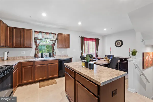 a kitchen with a stove a sink a refrigerator and wooden cabinets