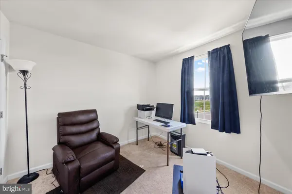 a work room with furniture and a flat screen tv