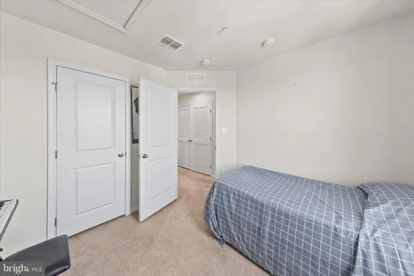 a living room with furniture and a walk in closet