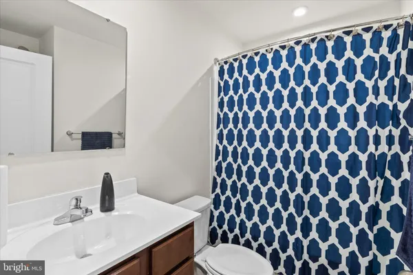 a bathroom with a sink toilet and mirror