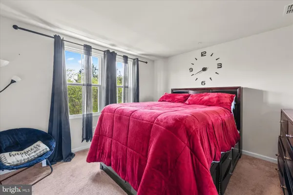 a bed sitting in a bedroom next to a window