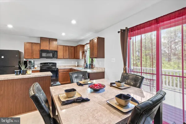 a kitchen with a table chairs stove and kitchen island
