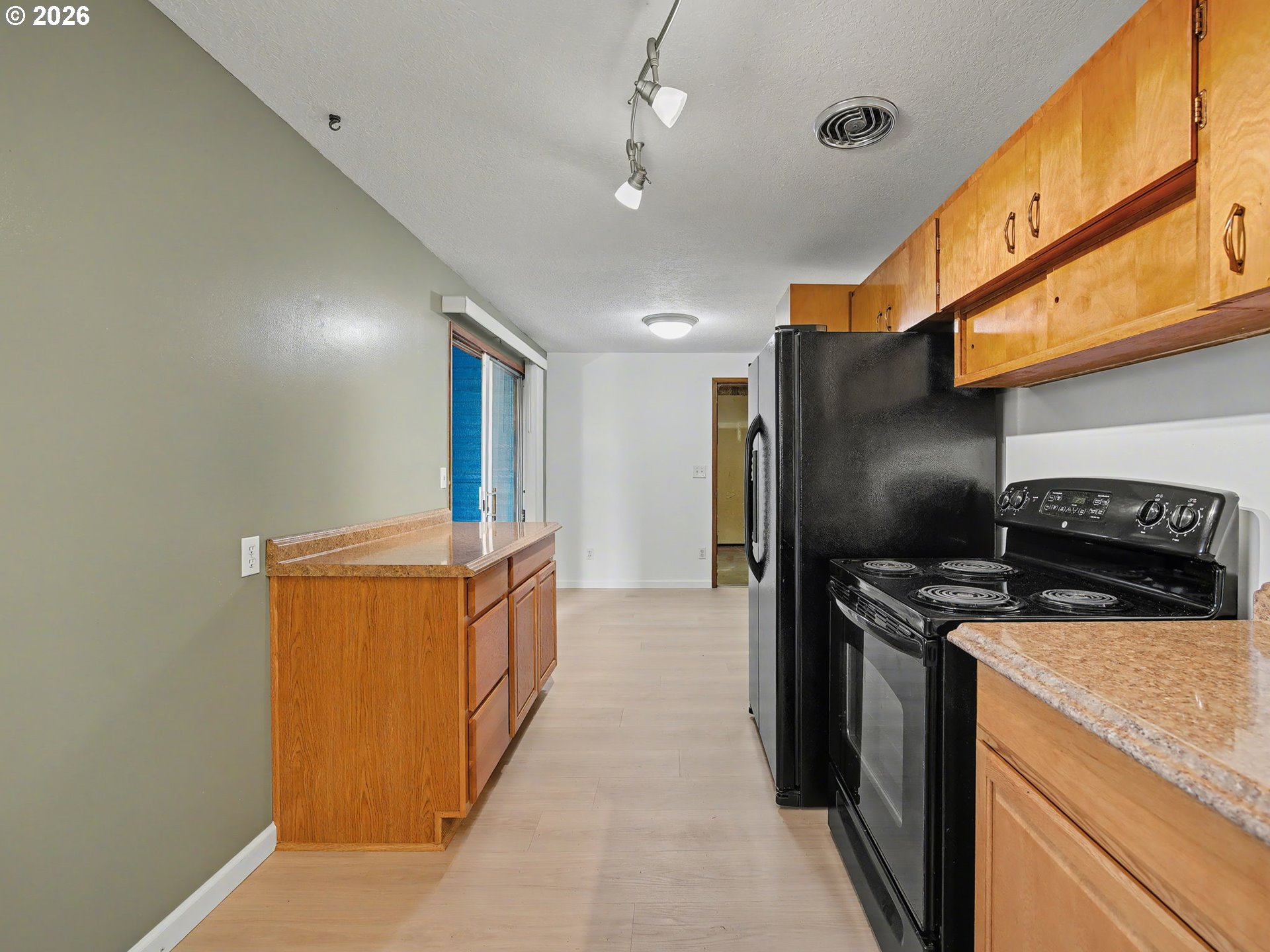 1780 Southeast 2nd Place Gresham, OR 97080 - Photo 11 of 25 a kitchen with stainless steel appliances granite countertop a refrigerator a stove and a sink with wooden floor