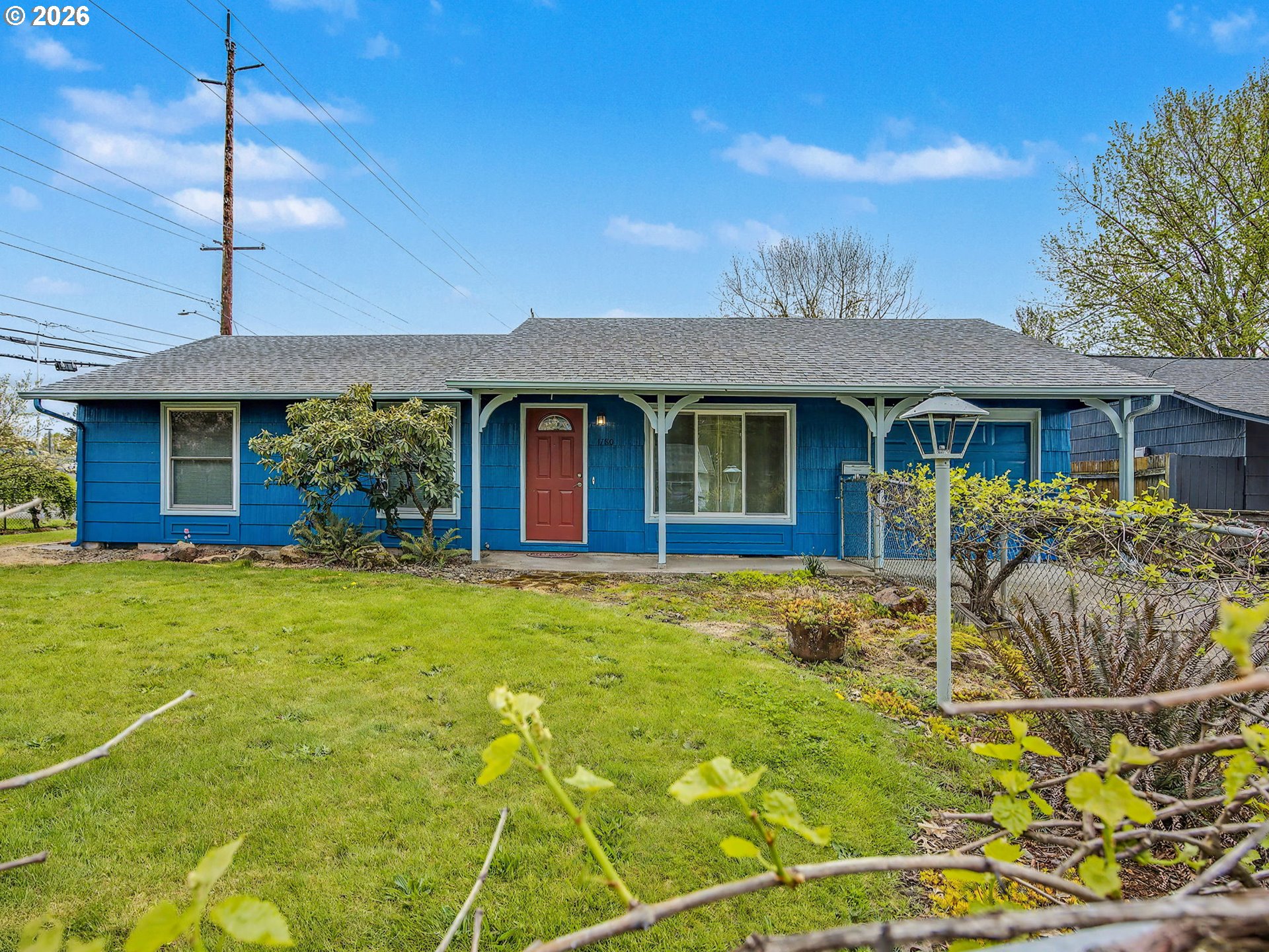 1780 Southeast 2nd Place Gresham, OR 97080 - Photo 2 of 25 a view of a house with table and chairs under an umbrella