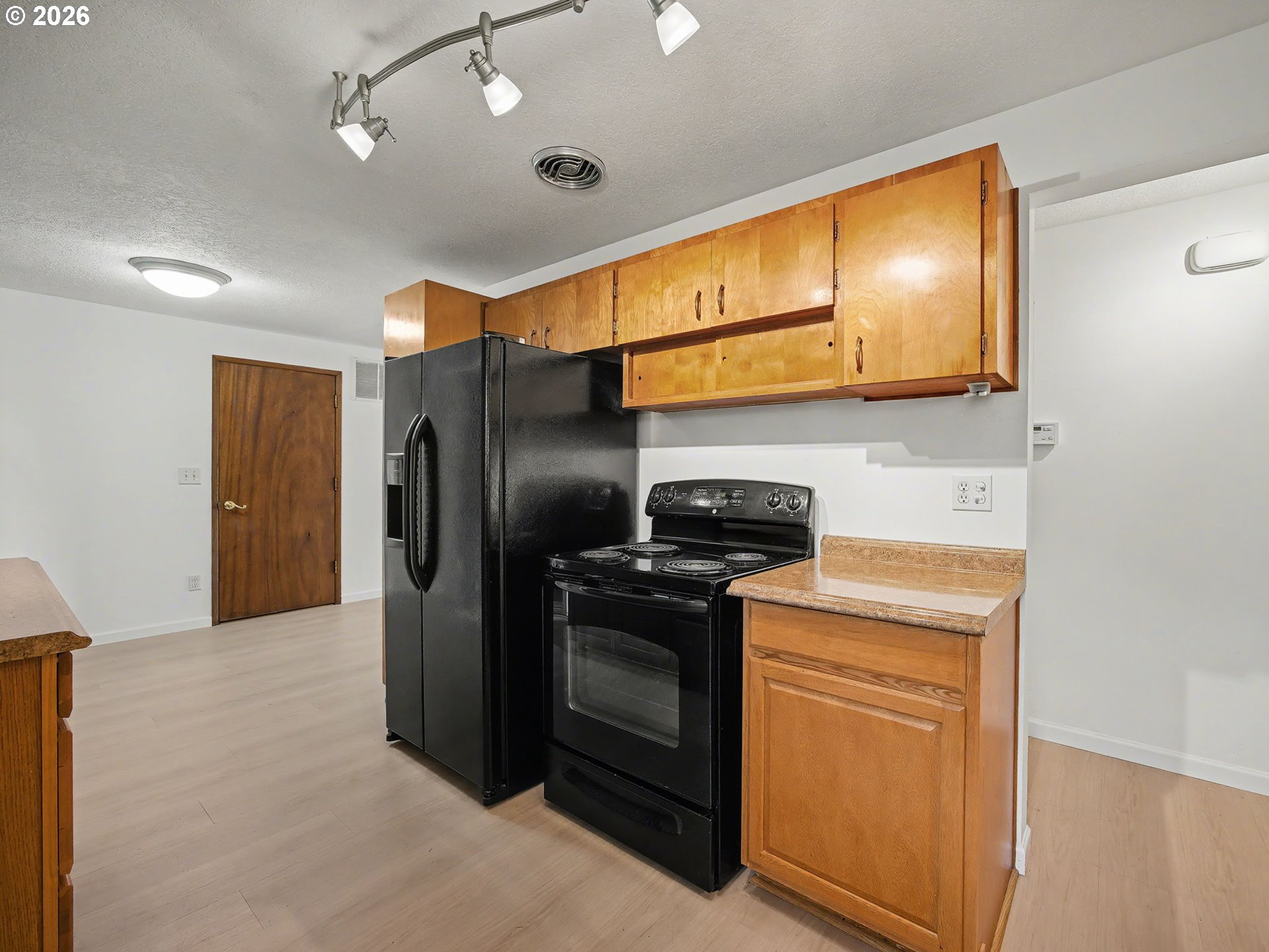 1780 Southeast 2nd Place Gresham, OR 97080 - Photo 10 of 25 a kitchen with stainless steel appliances granite countertop a refrigerator a sink and a stove
