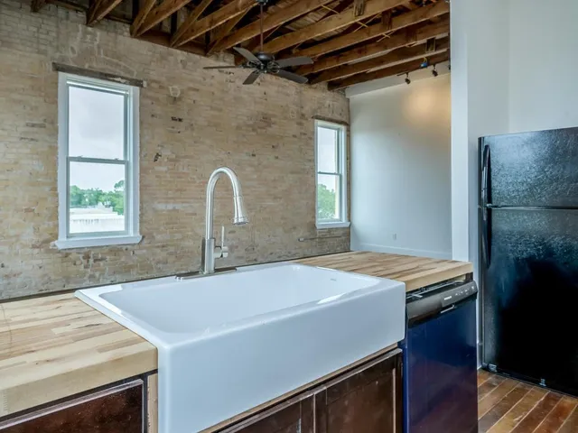 a kitchen with a sink a stove and a refrigerator