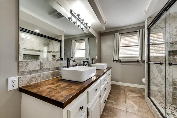 a living room with stainless steel appliances granite countertop a sink window and cabinets