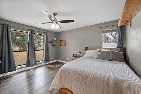 a bedroom with a large bed and a window