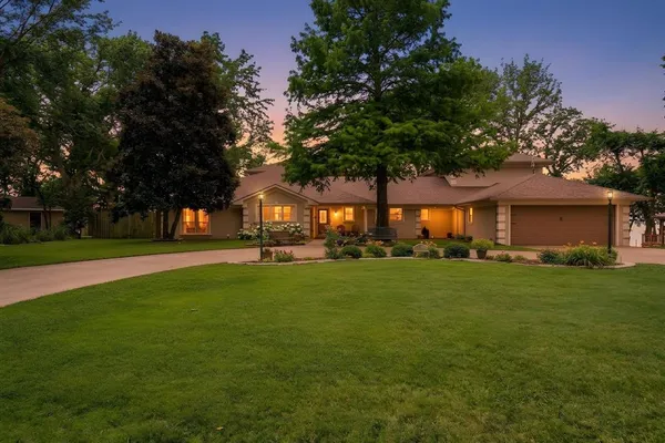 a view of a house with backyard and a tree