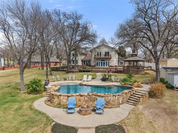 a view of a house with swimming pool and a yard