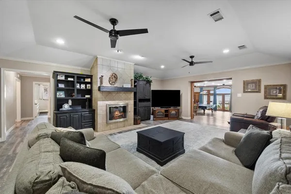 a living room with furniture a flat screen tv and a fireplace