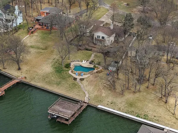 an aerial view of a house with a yard