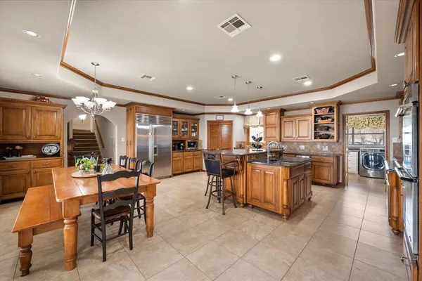 a living room with lots of furniture and kitchen view