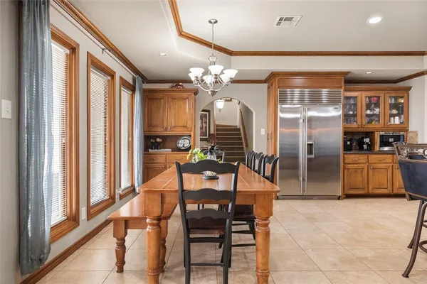 a kitchen with stainless steel appliances kitchen island granite countertop a refrigerator and microwave