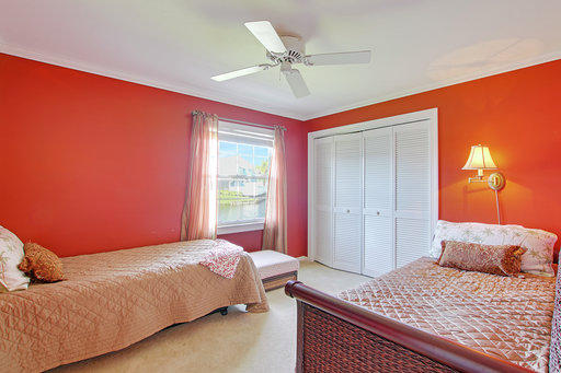 814 Ocean Dunes Circle Jupiter, FL 33477 - Photo 15 of 34 a bedroom with a bed and a window