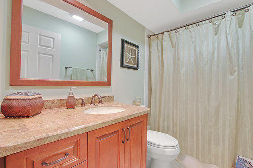 814 Ocean Dunes Circle Jupiter, FL 33477 - Photo 16 of 34 a bathroom with a granite countertop sink and a toilet