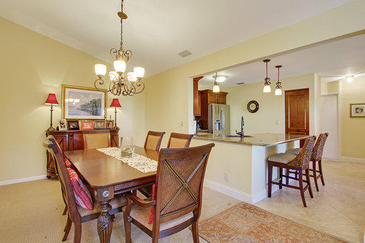 814 Ocean Dunes Circle Jupiter, FL 33477 - Photo 26 of 34 a view of a dining room with furniture and chandelier
