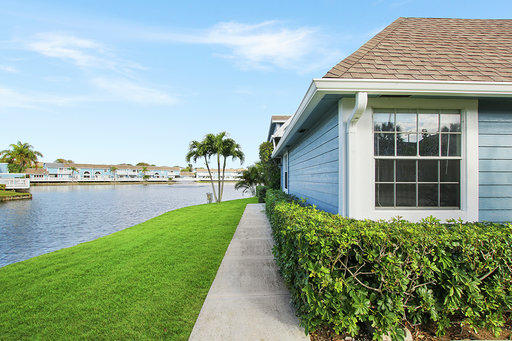 814 Ocean Dunes Circle Jupiter, FL 33477 - Photo 30 of 34 a front view of a house with garden