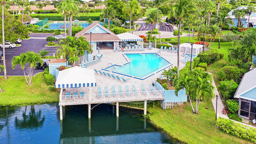 814 Ocean Dunes Circle Jupiter, FL 33477 - Photo 34 of 34 a view of a swimming pool with lawn chairs and plants