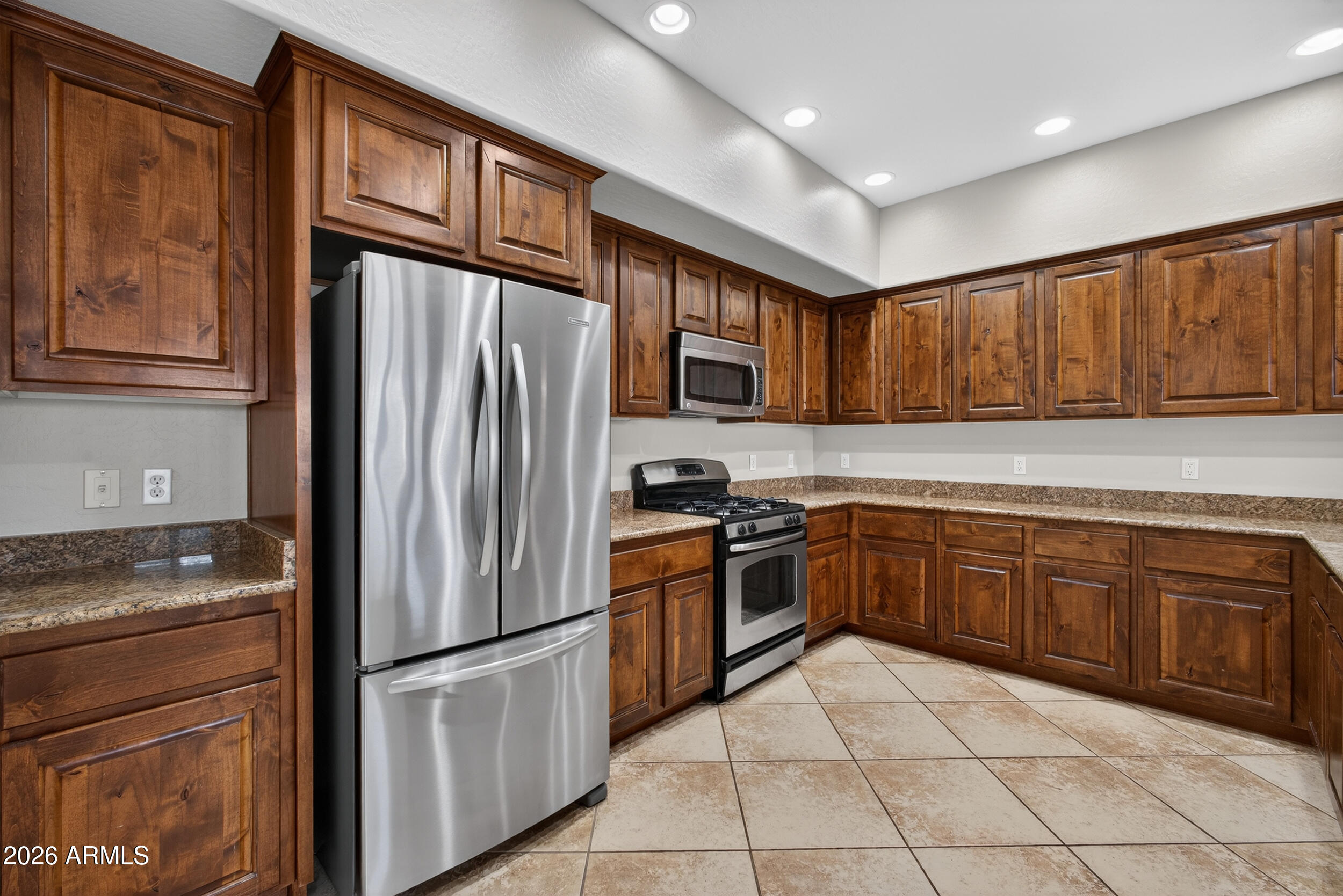 4777 South Fulton Ranch Boulevard, Unit 2044 Chandler, AZ 85248 - Photo 11 of 46 a kitchen with granite countertop stainless steel appliances a refrigerator stove top oven and cabinets