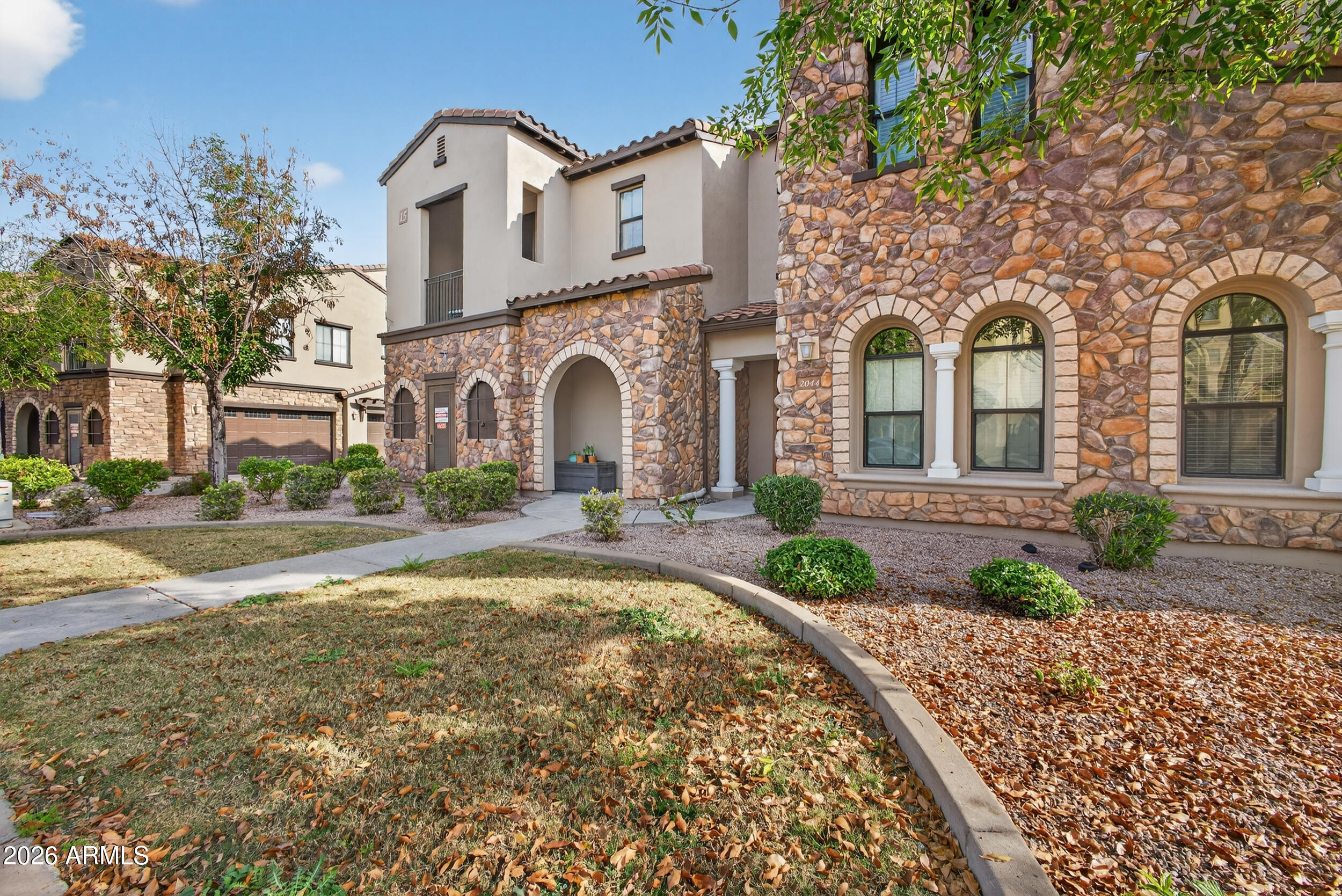 4777 South Fulton Ranch Boulevard, Unit 2044 Chandler, AZ 85248 - Photo 2 of 46 a front view of a house with garden