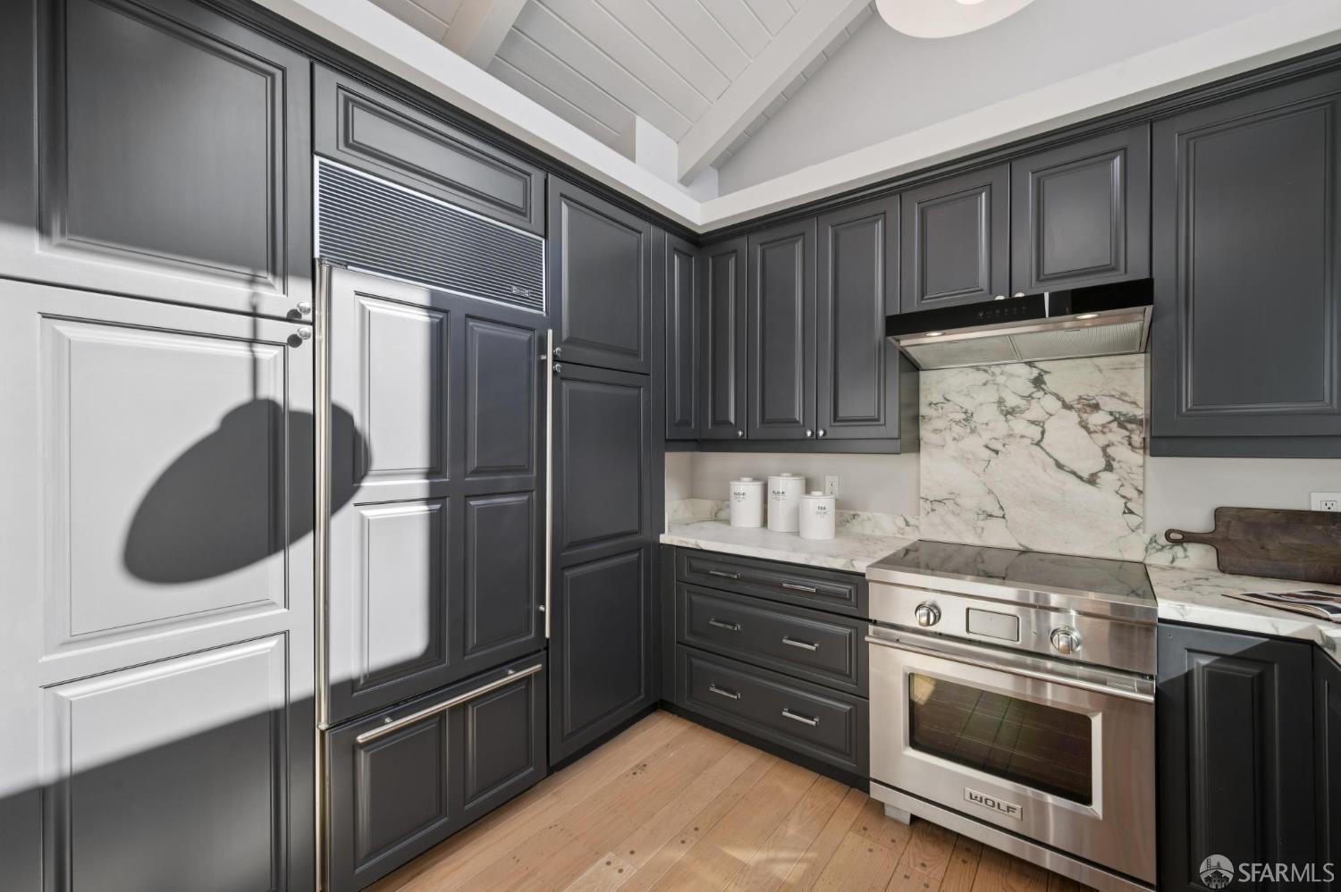 2023 22nd Street San Francisco, CA 94107 - Photo 16 of 56 a kitchen with stainless steel appliances and granite countertop wooden cabinets