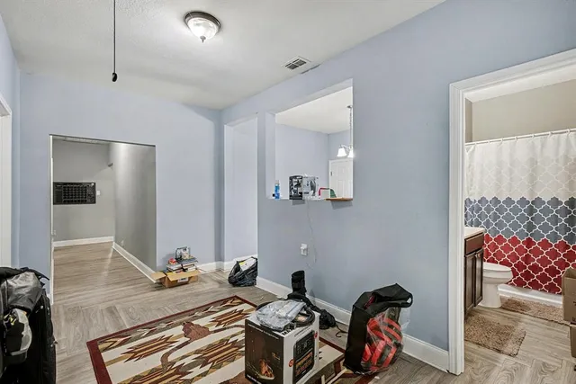 a bathroom with a sink a toilet and shower curtain