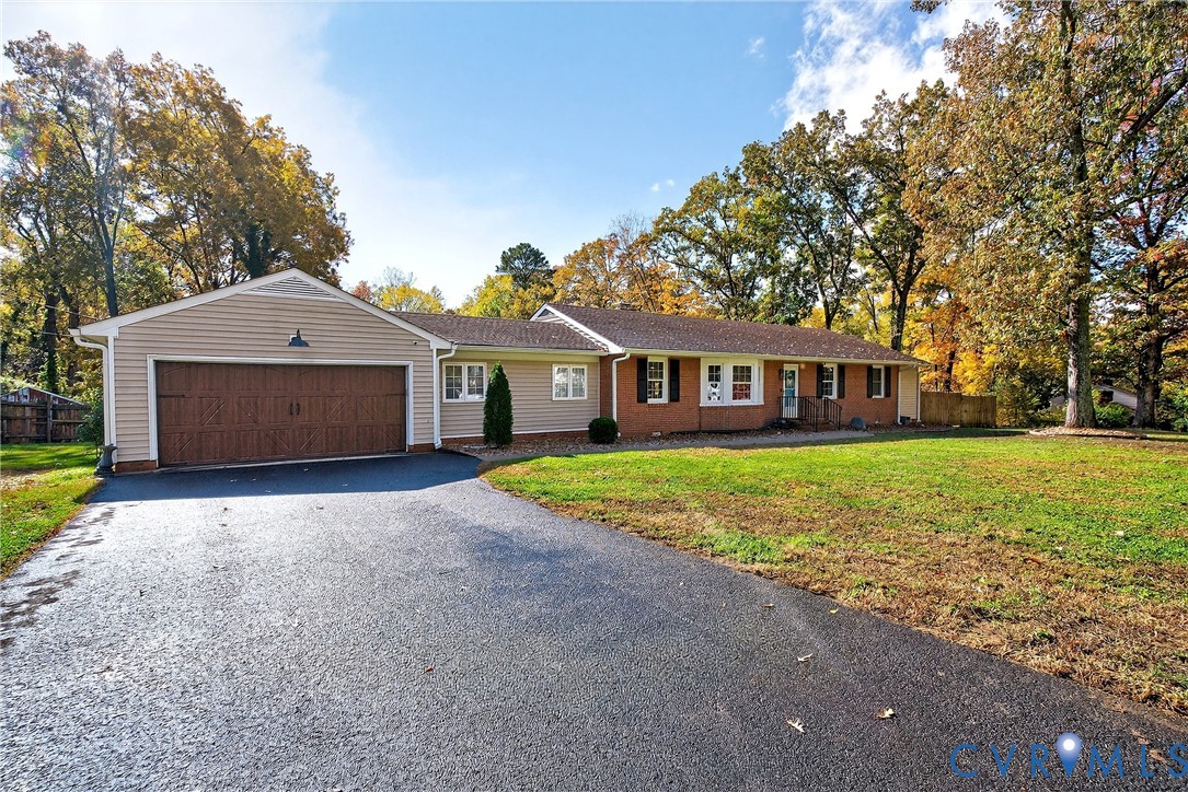 8751 Trent Road Richmond, VA 23235 - Photo 1 of 1 Ranch-style home with asphalt driveway, a garage,