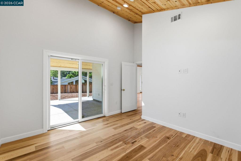 3196 Rohrer Drive Lafayette, CA 94549 - Photo 13 of 30 a view of an empty room with wooden floor and a window