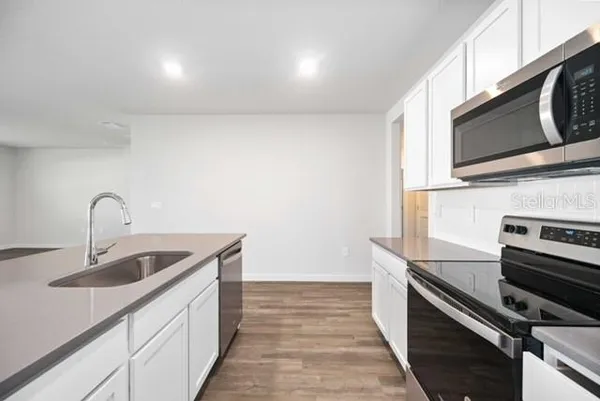 a kitchen with a sink and stainless steel appliances