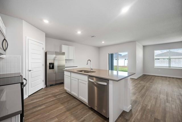 3703 Hatchery Way Lakewood Ranch, FL 34211 - Photo 14 of 35 a kitchen with stainless steel appliances granite countertop a stove and a refrigerator