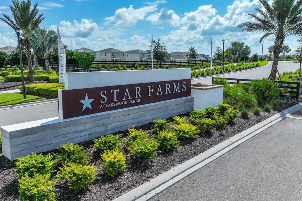 3703 Hatchery Way Lakewood Ranch, FL 34211 - Photo 2 of 35 a sign that is sitting in front of flowers